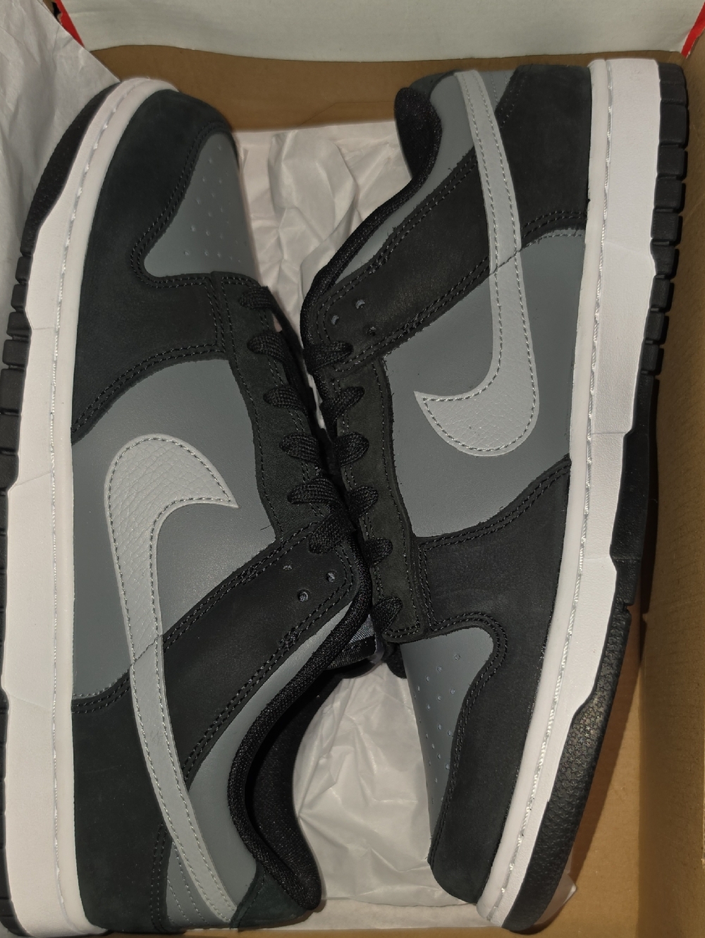 Nike Dunk Low Black Light Smoke Grey sneakers, featuring a black and grey leathe